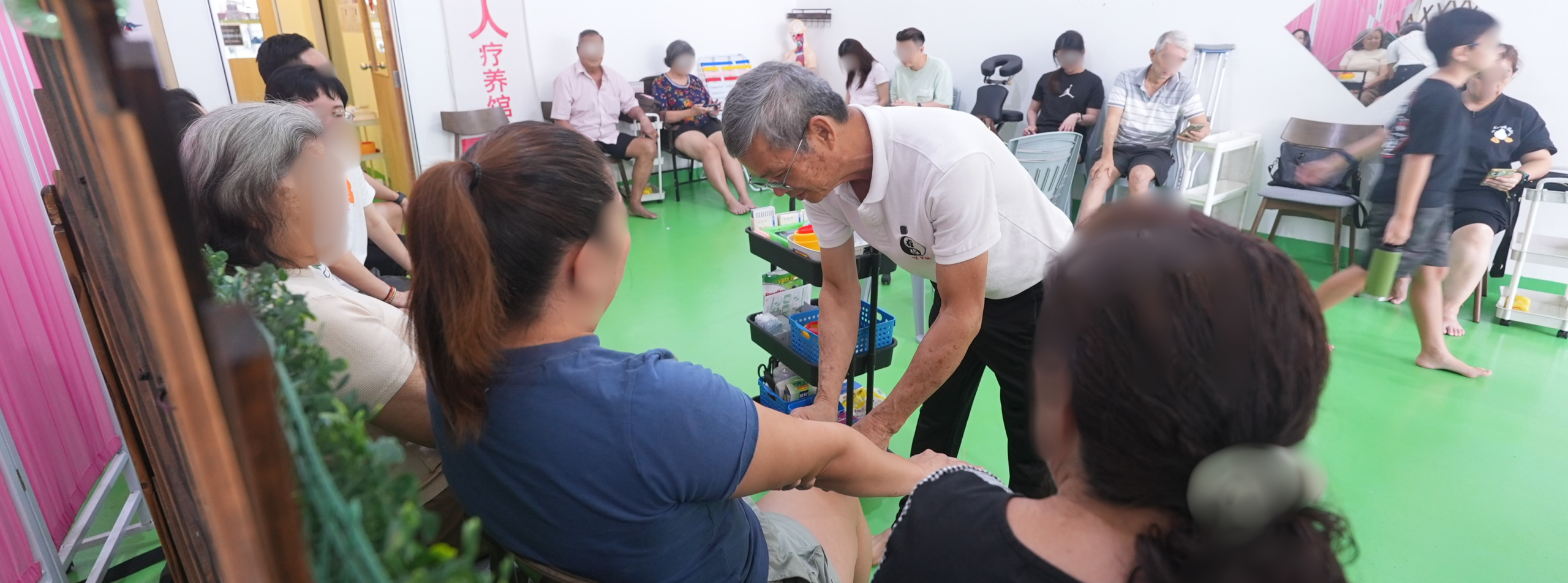 home Uncle Lim demonstrating hands-on care at You Yuan Ren TCM